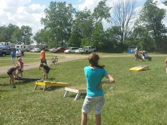 Kids playing corn hole on the big lawn