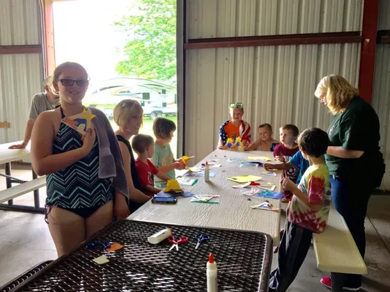 Kids making crafts at a long table